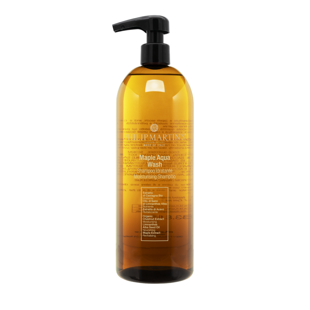 Amber plastic pump bottle containing Maple Aqua Wash moisturizing shampoo with a black dispenser.