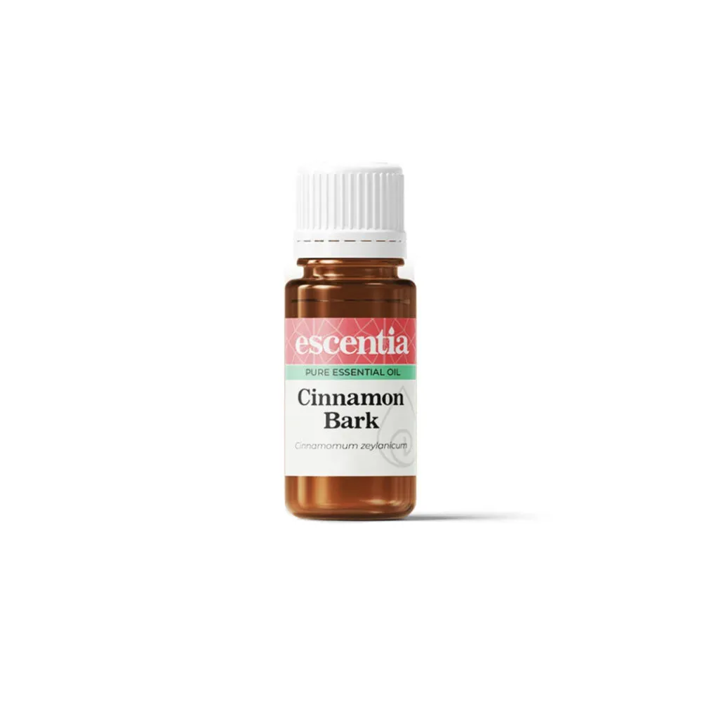 Bottle of Escentia pure cinnamon bark essential oil with white cap and amber glass, label reads Cinnamon Bark.