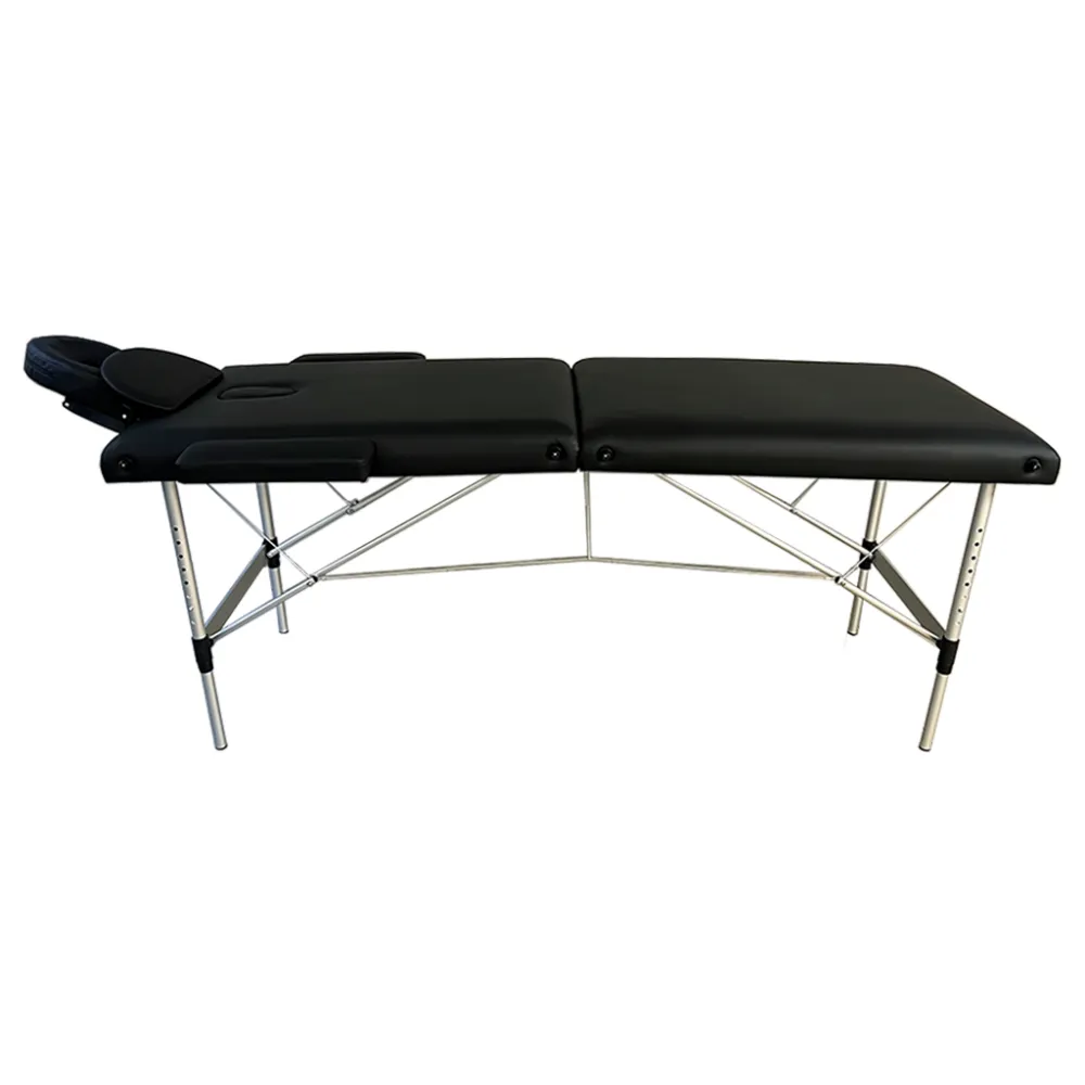 Portable massage table with black upholstery, face cradle, and adjustable metal legs.