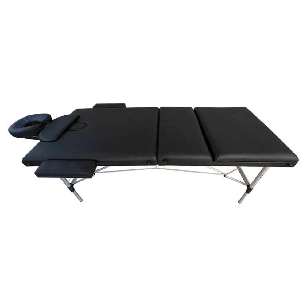 Black folding massage table with padded sections and face cradle, fully extended for a treatment session