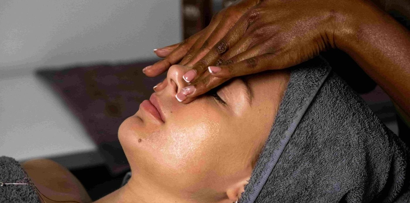 Therapist's hands during a facial treatment
