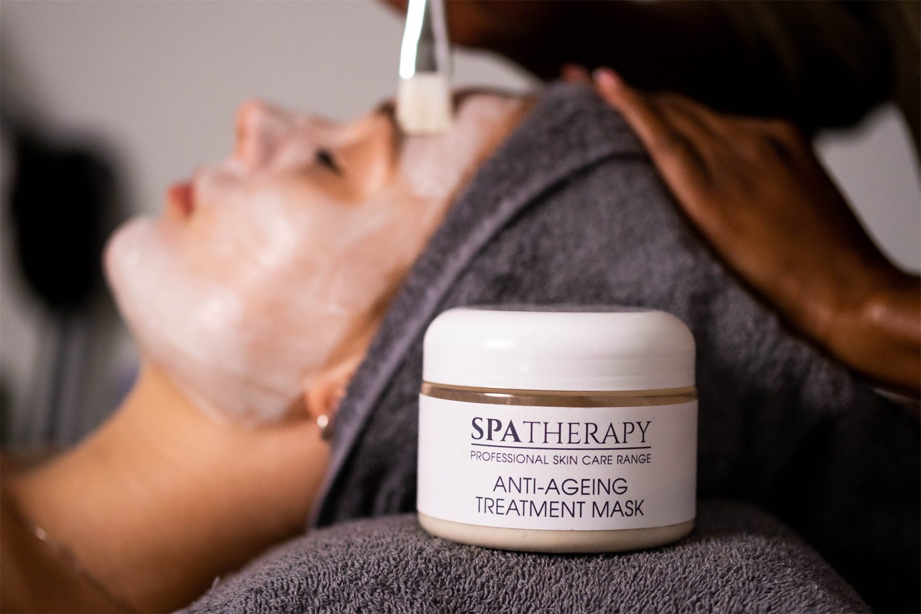 Client relaxing under a mask treatment
