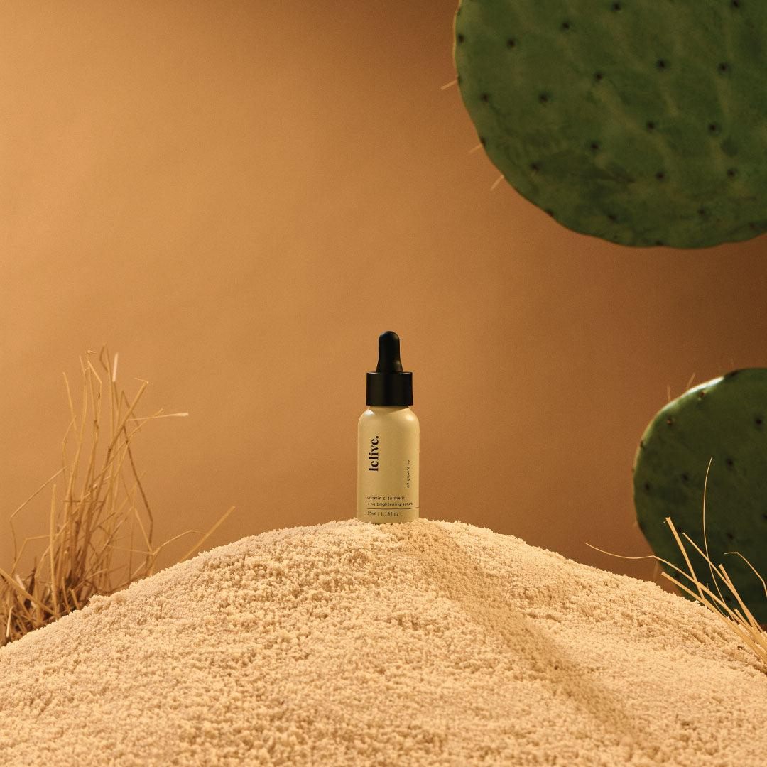 Spa Therapy serum bottle on sand